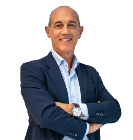 A smiling man in a blue suit with a light blue shirt stands with arms crossed, wearing a wristwatch and looking confidently at the camera. The background is transparent.